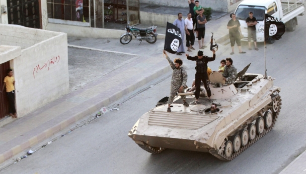 Reuters Militant Islamist fighters take part in a military parade along the streets of northern Raqqa province, June 30, 2014.
