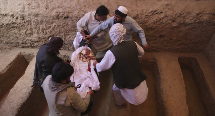 Afghans carry the body of a victim of the Dubai City wedding hall bombing during a mass funeral in Kabul, Afghanistan, Sunday, Aug.18, 2019. The deadly bombing at the wedding in Afghanistan's capital late Saturday that killed dozens of people was a stark reminder that the war-weary country faces daily threats not only from the long-established Taliban but also from a brutal local affiliate of the Islamic State group, which claimed responsibility for the attack. (AP Photo/Rafiq Maqbool)