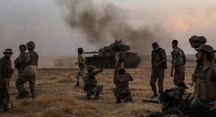 Turkish soldiers and Turkey-backed Syrian fighters gather on the northern outskirts of the Syrian city of Manbij, near the Turkish border, on Oct. 14, 2019. Photo: Zein Al Rifai/AFP via Getty Images